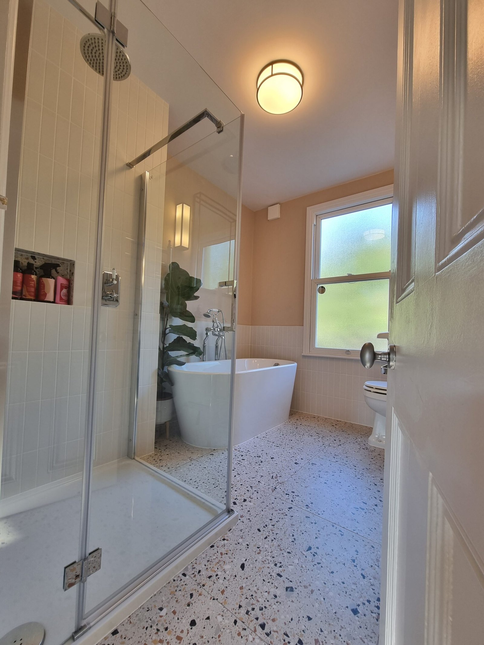 Family bathroom with terrazzo floor and natural light