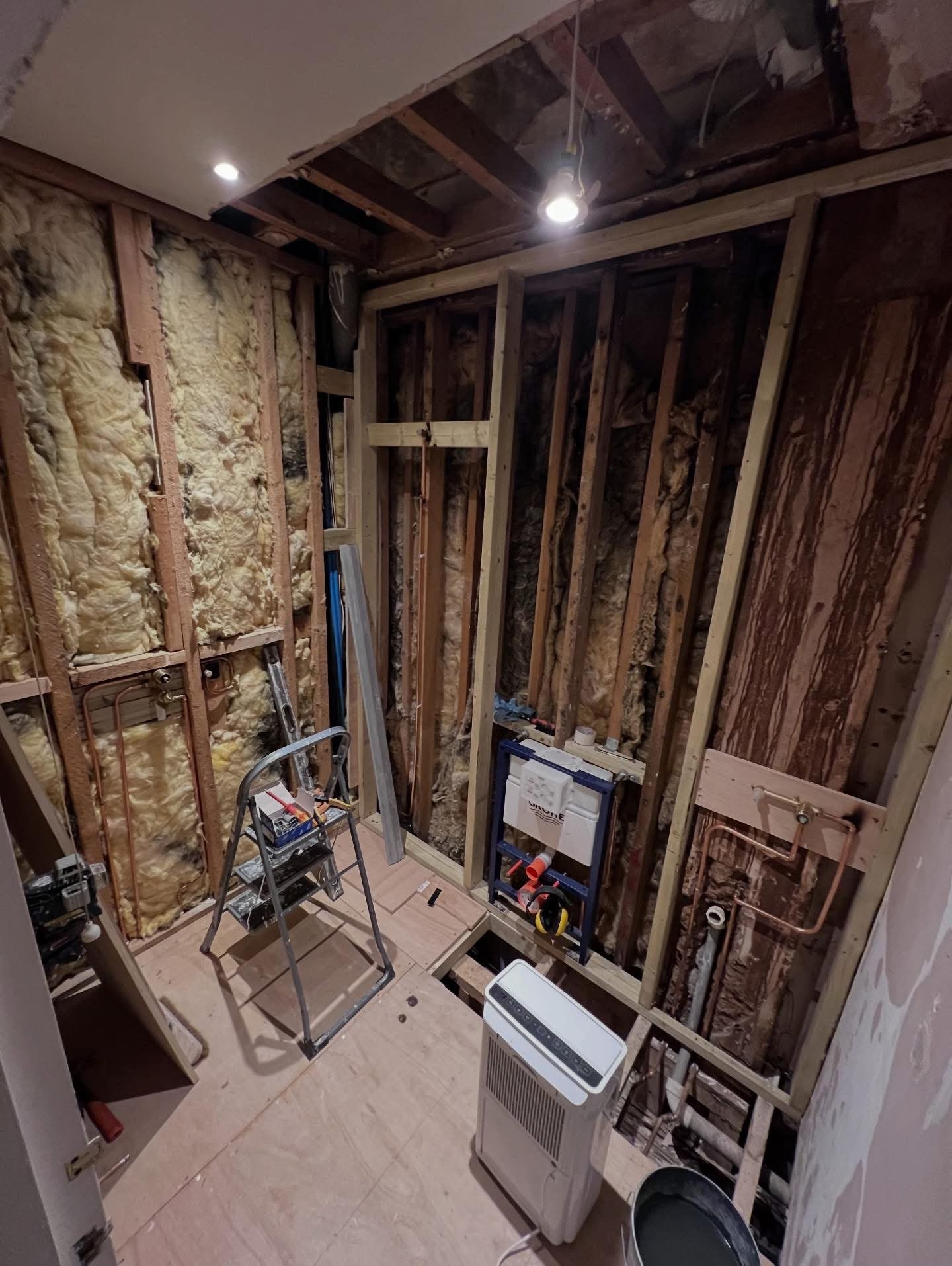 Bathroom first fix with concealed cistern frame and copper pipework installed before boarding