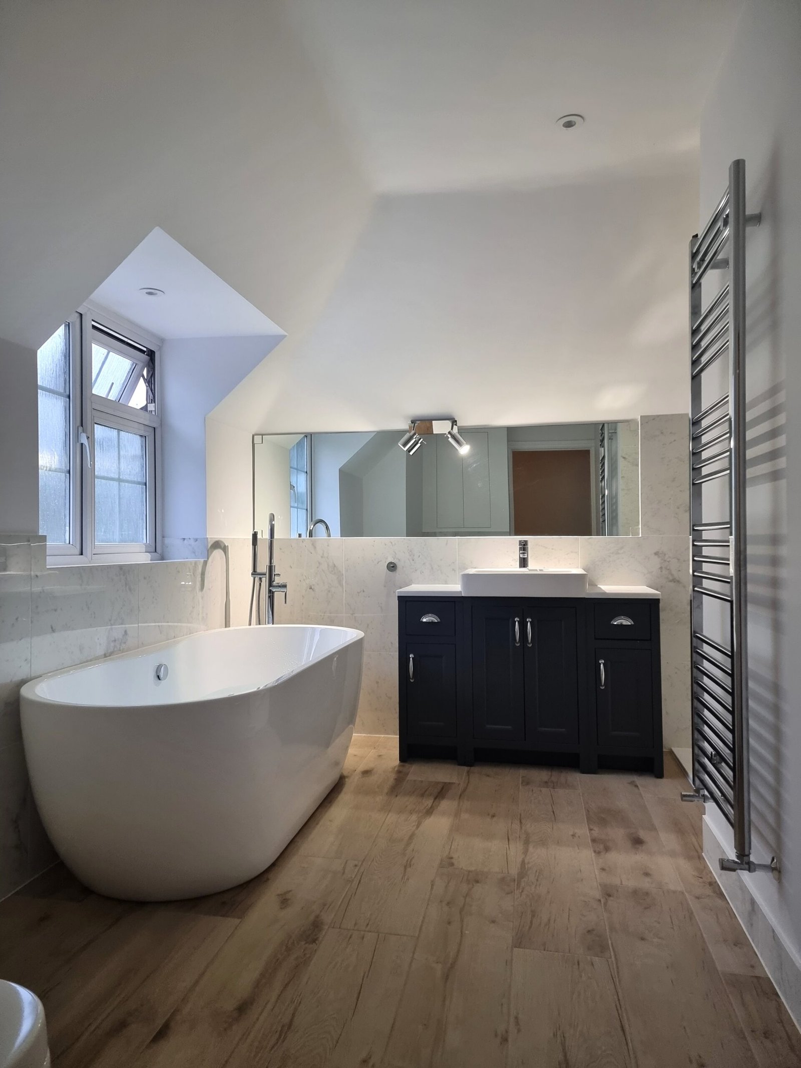 Family bathroom freestanding bath with porcelain tiles, North London