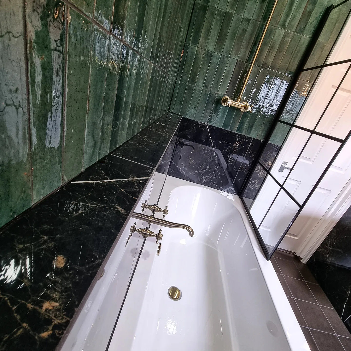 Green zellige wall tiling with marble bath surround, Crouch End