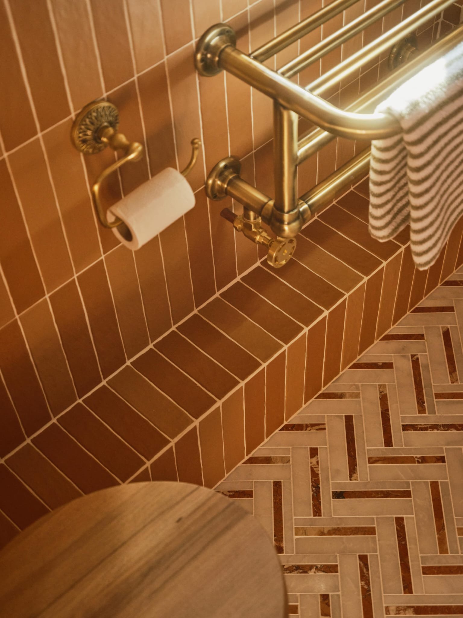 Terracotta chevron wall tiling with marble herringbone floor, Crouch End